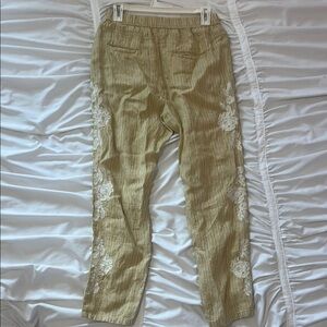 Yellow striped pants with lace embroidery detail